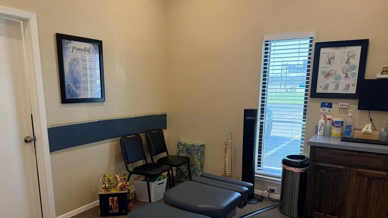 A Denton Chiropractic Center staff member preparing a patient for treatment