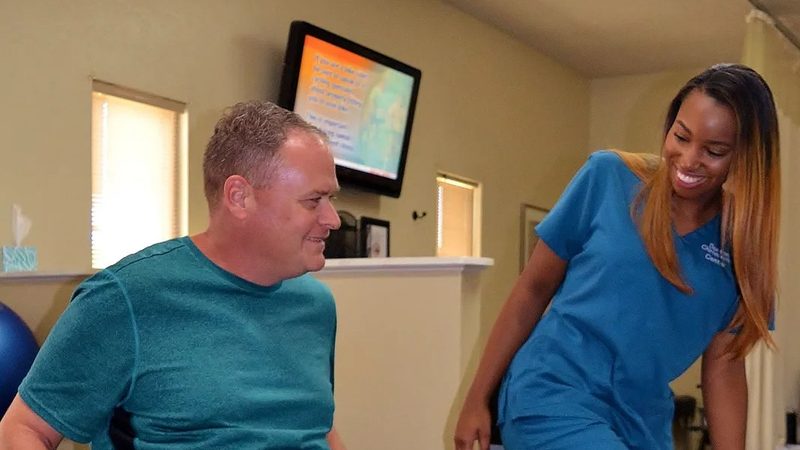 A patient completing guided rehabilitative exercise with a staff member